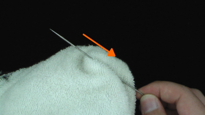 Clean the needle with a rag
